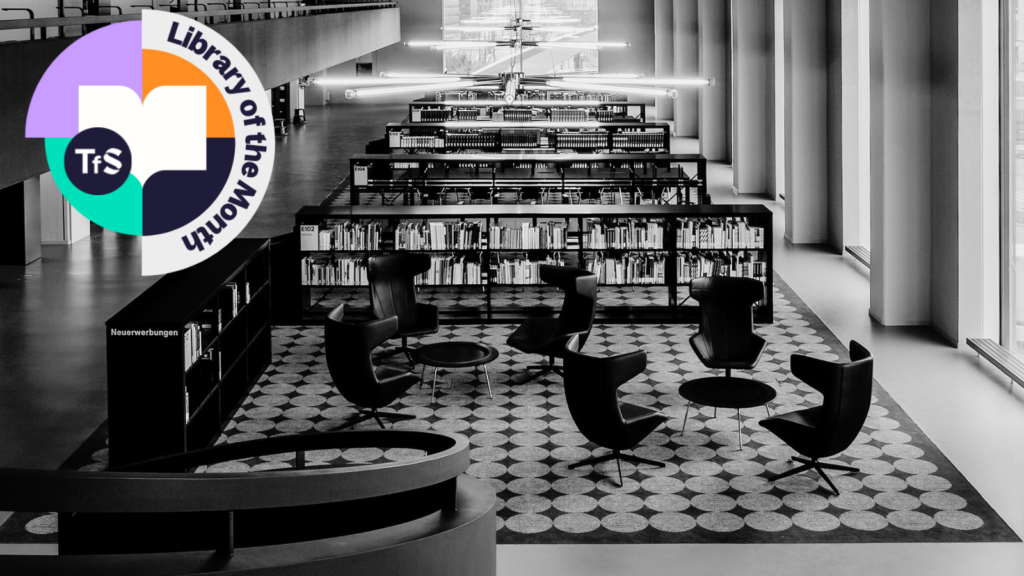 Black and white inside of a library, bookshelves and chairs, with Library of the Month logo